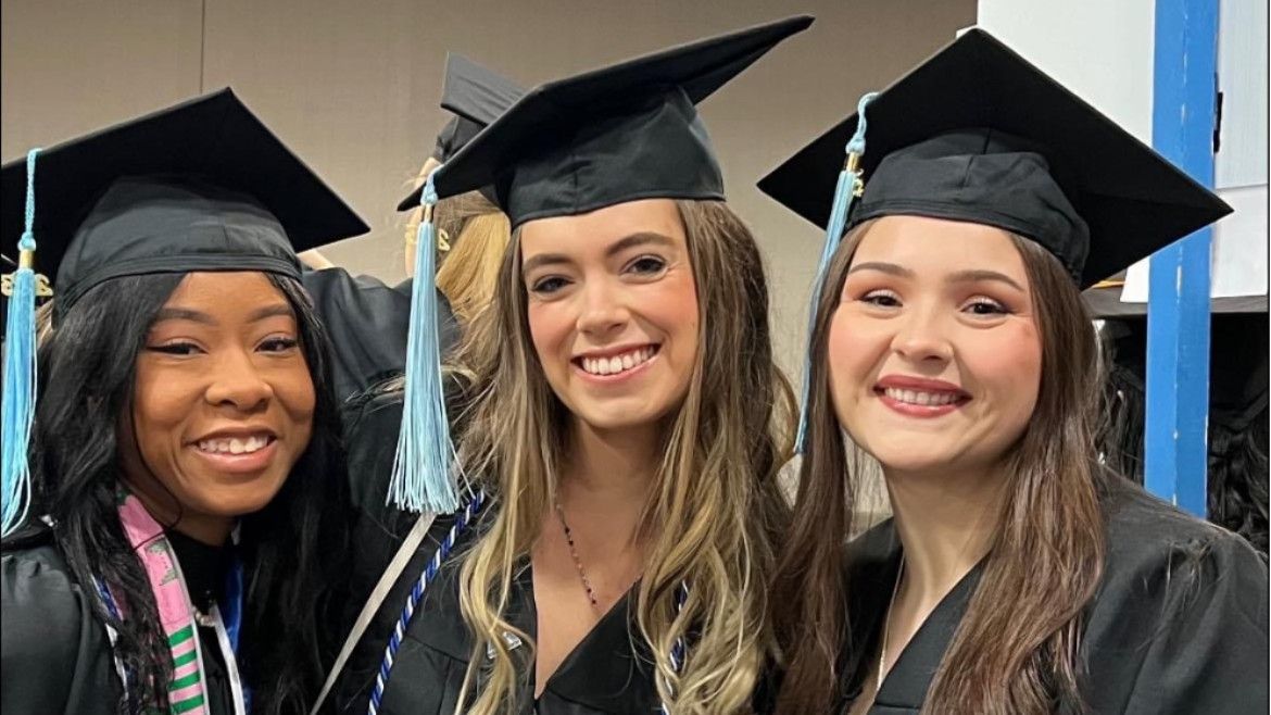 College of Education students pose for a photo at graduation