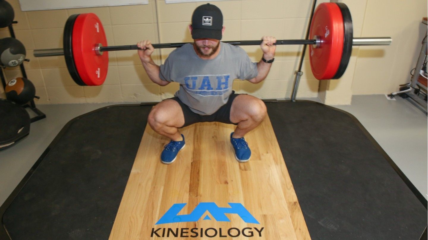 a man squats weights
