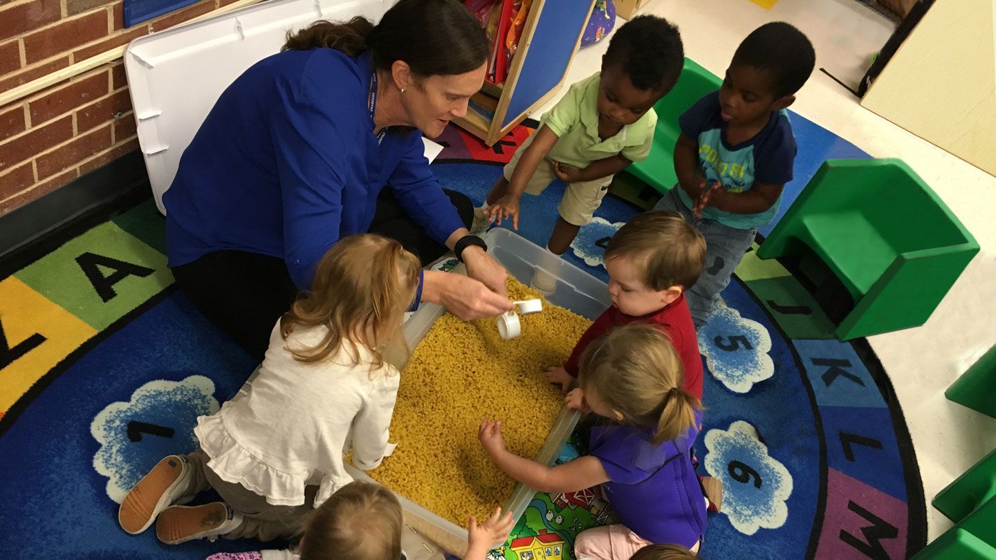 Children play in a sensory bin
