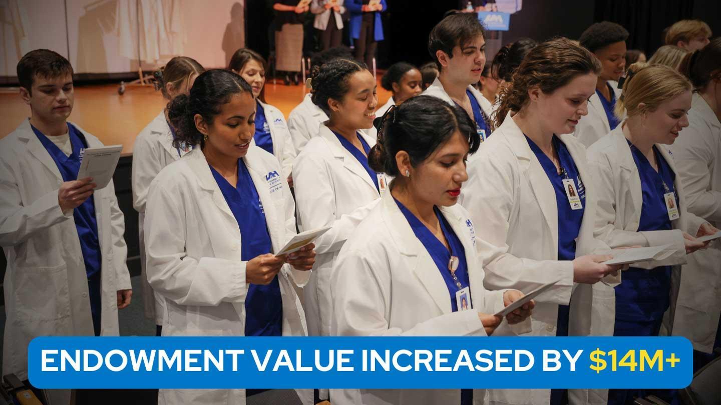 students in lab coats at a ceremony
