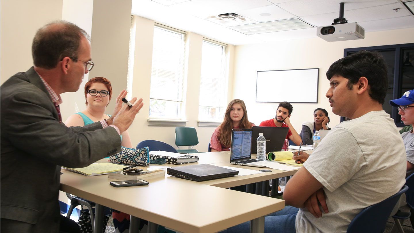 students are taught by their teacher at their table