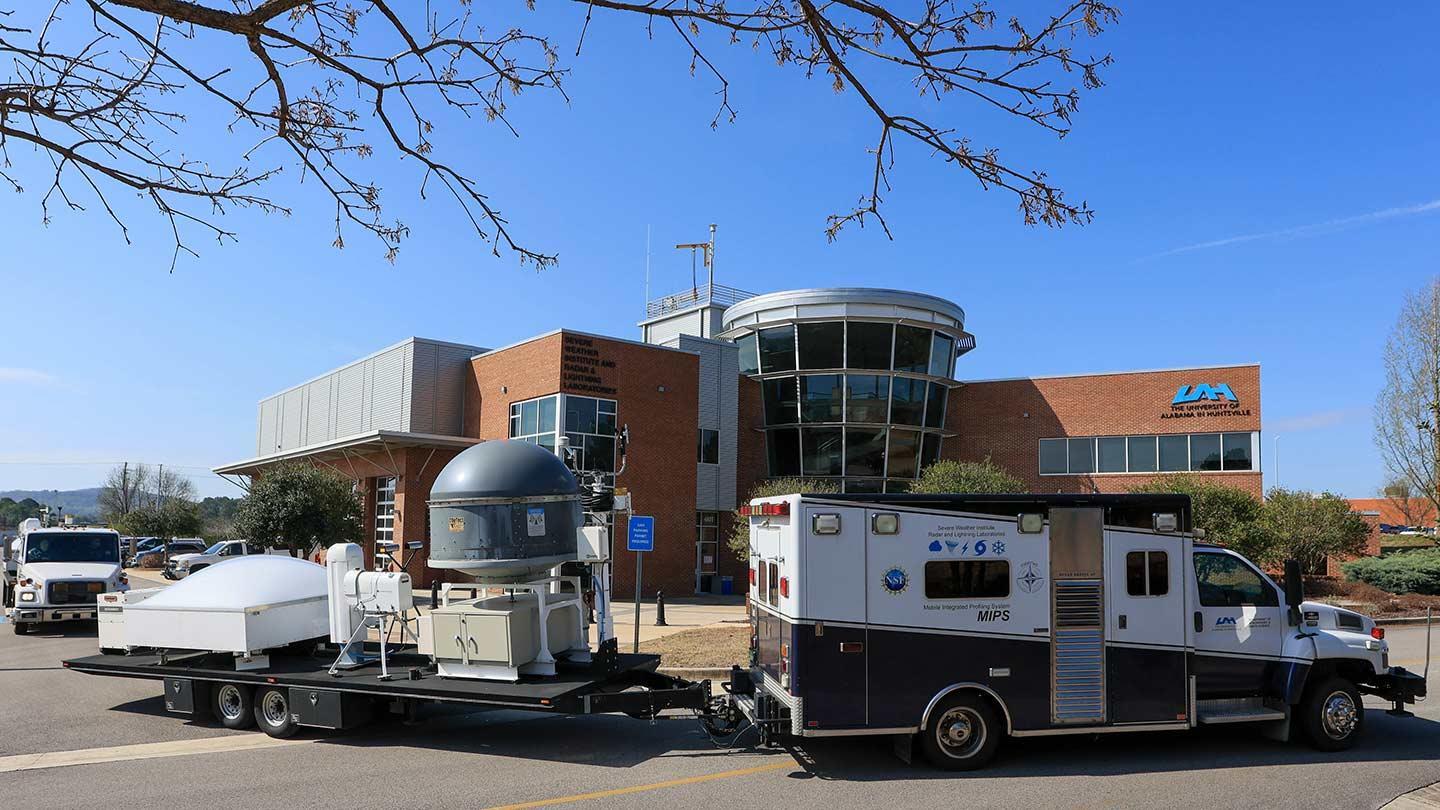 swirll building exterior with weather equipment parked in front