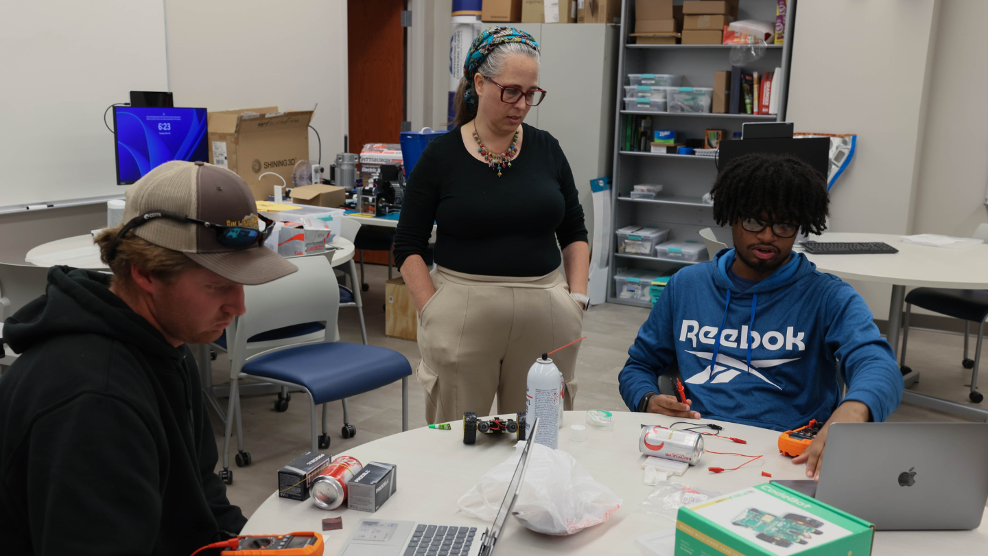 Engineering Technology students receive feedback and instruction from their professor.