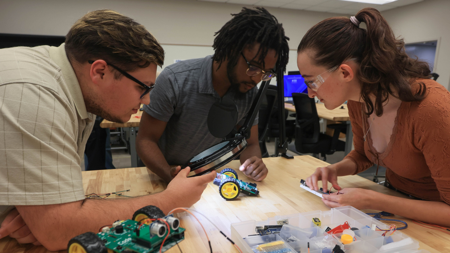 Engineering Technology students at UAH collaborate on robotics at the lab.