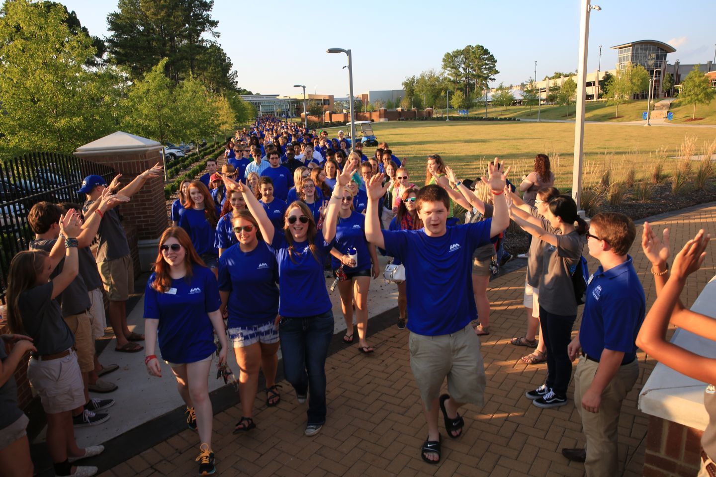 students cheer on a walkway