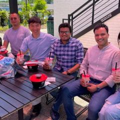 professor and students celebrating at a outdoor restaurant