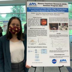 Sara Mog stands in front of her fiber optic heat flux sensor project at the 2021 Summer HCR Expo