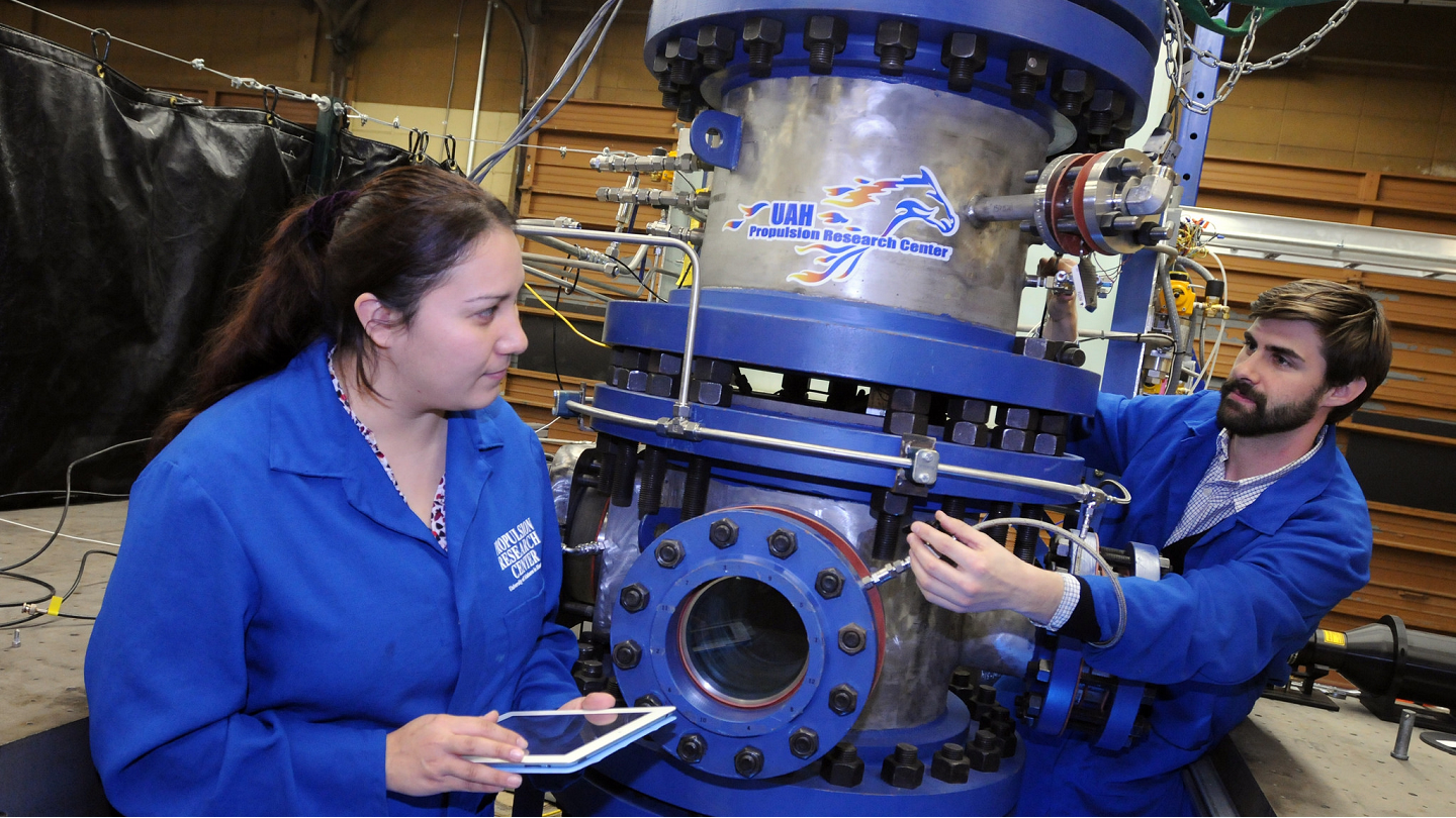 two people use large machinery