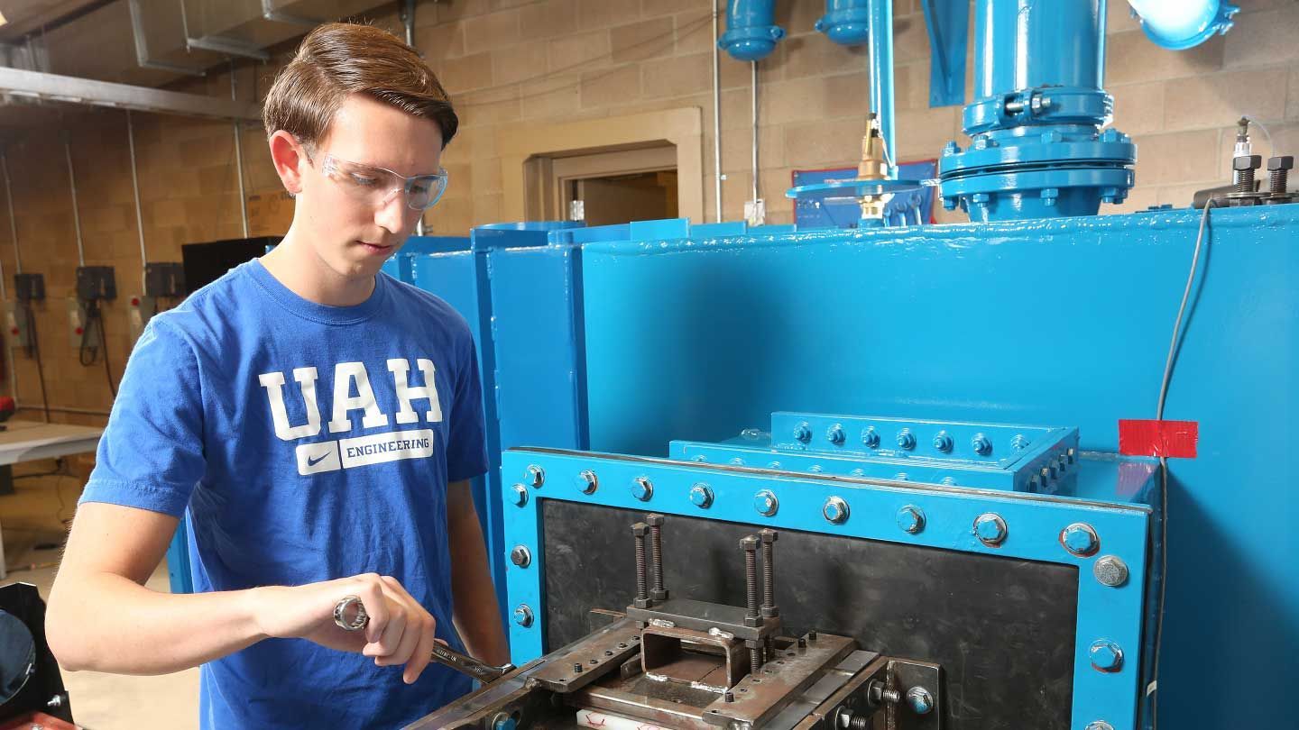 a wind tunnel is examined by a man
