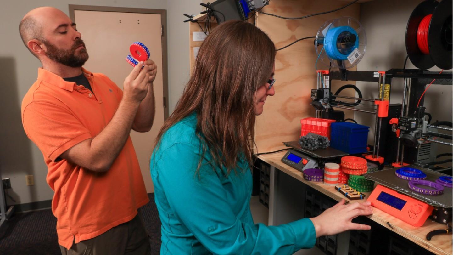 a man and woman examine gizmos