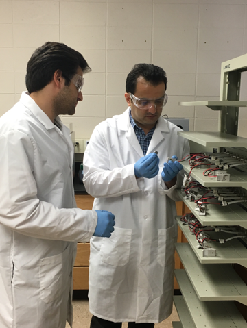 Dr. Majid Beidaghi and PhD student Mr. Armin VahidMohammadi stand at a shelf of objects