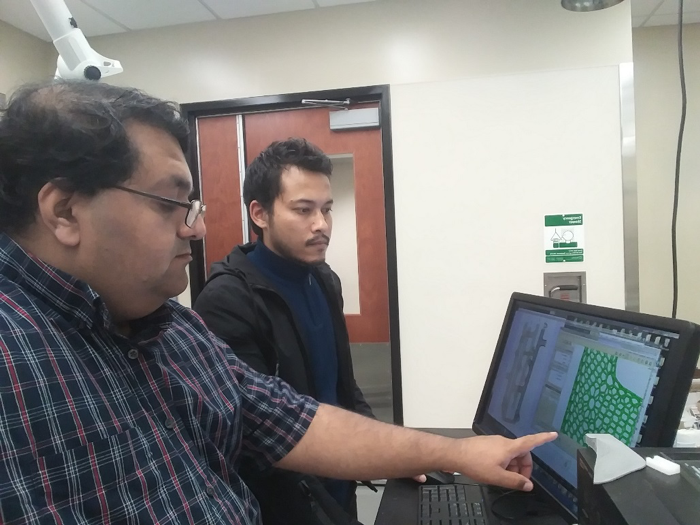 Dr. Vinu Unnikrishnan and Mr. Sushan Nakarmi examine a monitor