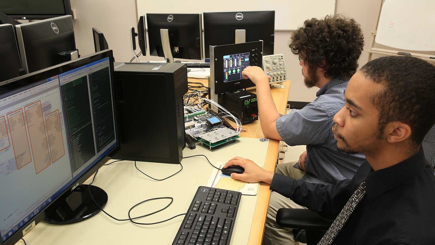 Students work on computer hardware