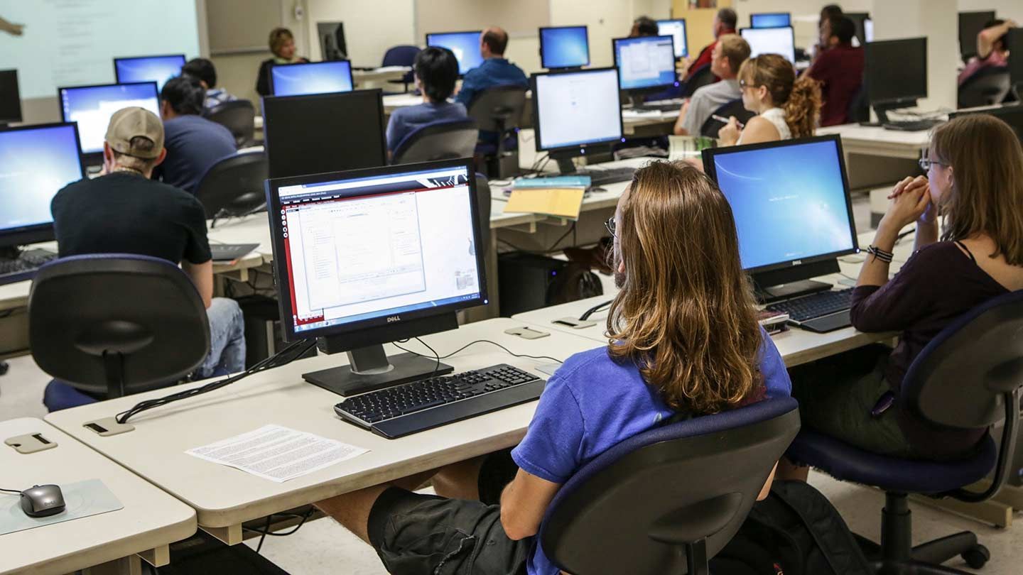 Students work on computer in a classroom