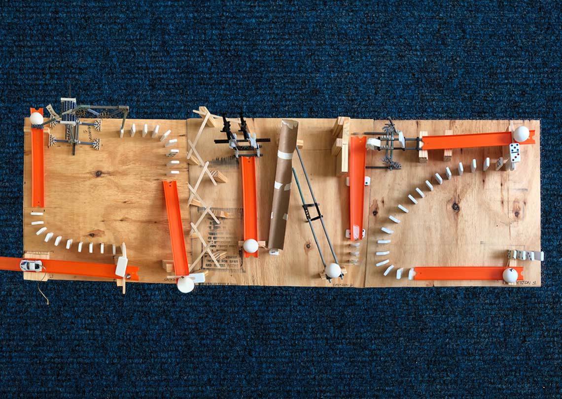 Rube Goldberg Machine (RGM) designed to turn a page in a book