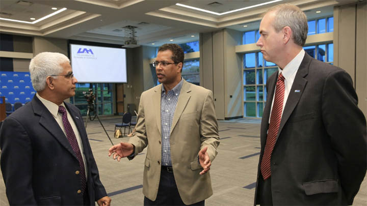 uah faculty in conversation inside uah campus building