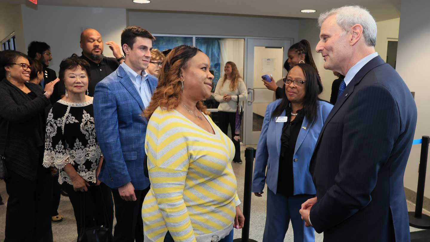 Guests smiling and conversing with UAH President Dr. Leo