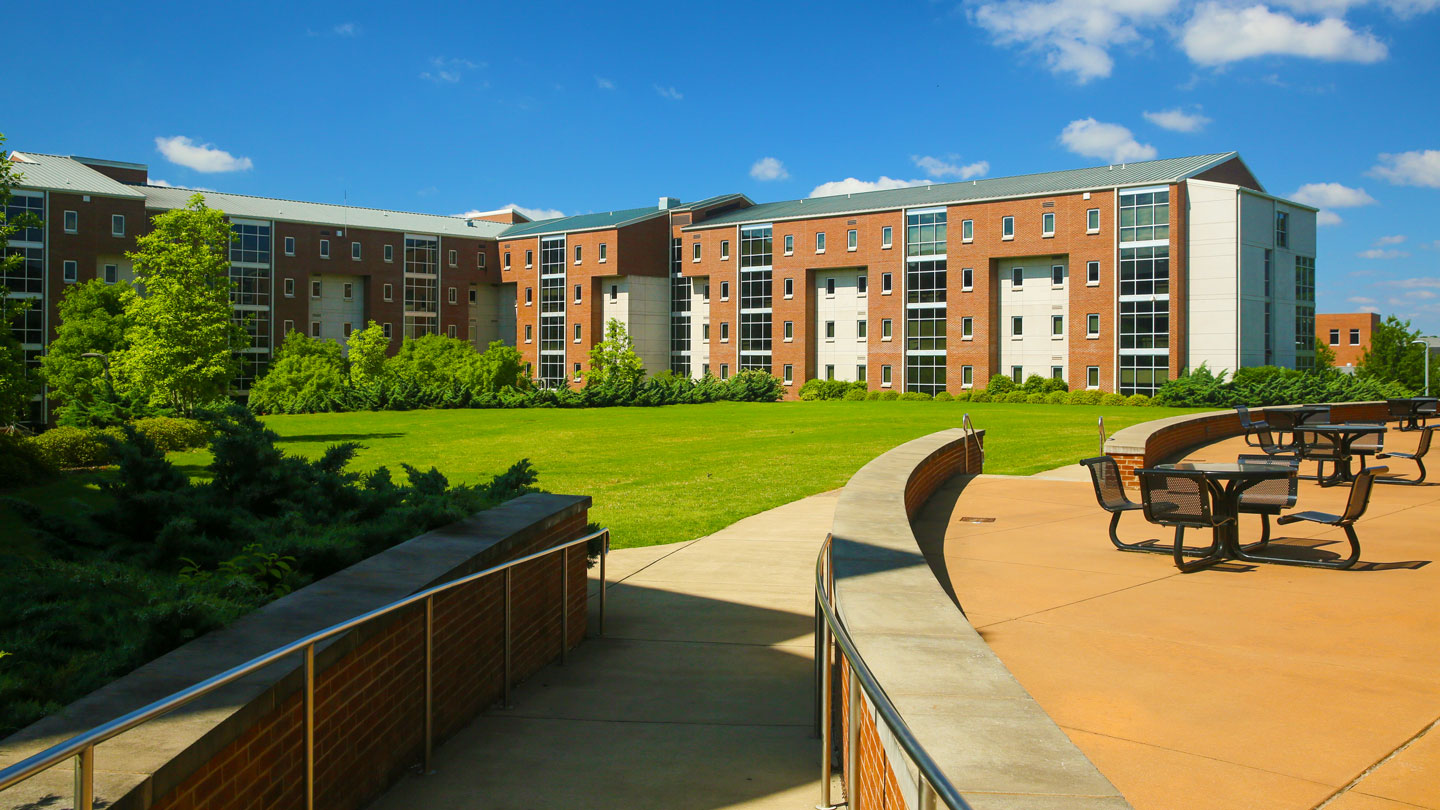 the patio, courtyard, and landscaping of the charger village original residence hall at uah