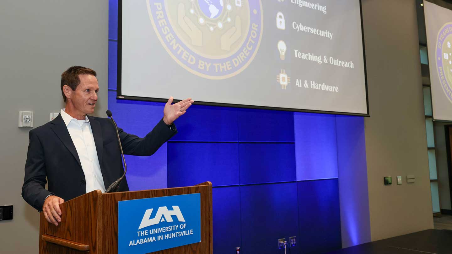 Dr. Tommy Morris, founding director of the Center for Cybersecurity Research and Education at The University of Alabama in Huntsville accepting 10-years of Excellence Coin during CCRE 10th Anniversary celebration.