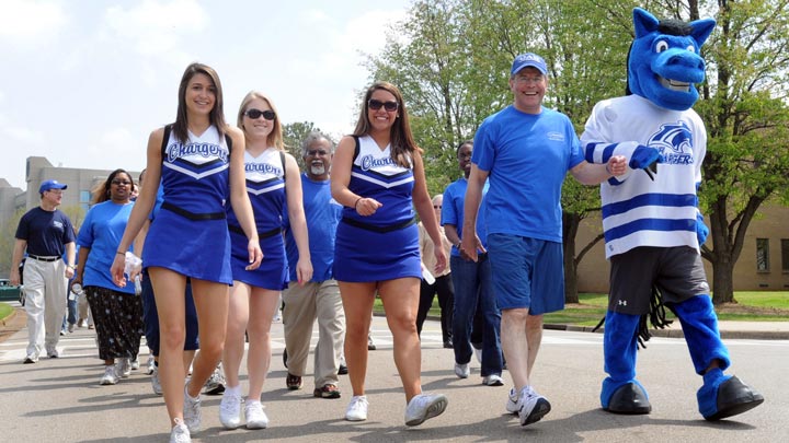 Dr. Williams walks with Charger Blue and the UAH cheerleaders during the Charger Walk event in 2008.