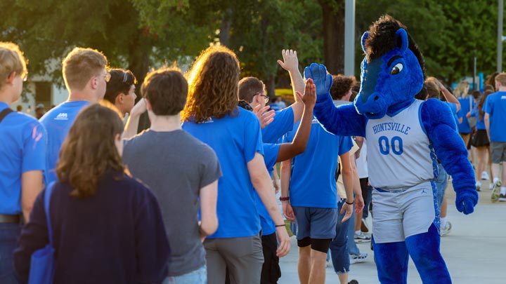 Charger Blue greets students ahead of the Charger Blue BBQ during UAH Week of Welcome (WOW) in August 2024.