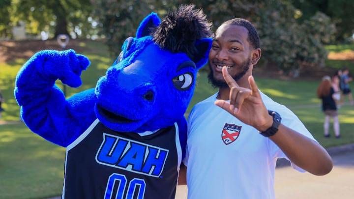 Charger Blue poses with a student during UAH Week of Welcome (WOW) in August 2026.