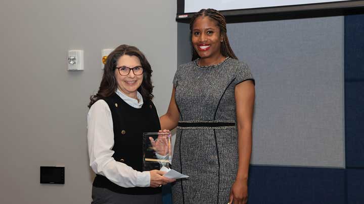 Dr. Kristy Lee, right, presents the Staff Excellence Award to Beth Hodges.