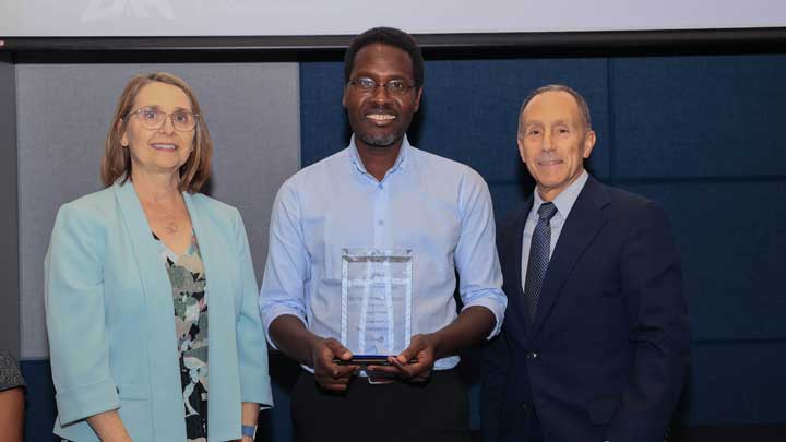 Dr. Victor Ogungbe, center, receives the Outstanding Faculty Award for the College of Science from Dr. Terri Johnson, associate dean of undergraduate affairs, left, and Dr. David Puleo.
