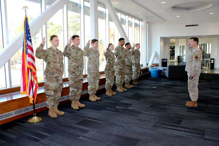 U.S. Air Force Capt. Brett Collins, right, one of the Air Force ROTC cadre officers at The University of Alabama in Huntsville (UAH) swears in UAH’s first group of seven cadets to be chosen for enlistment on at Charger Union on the UAH campus.