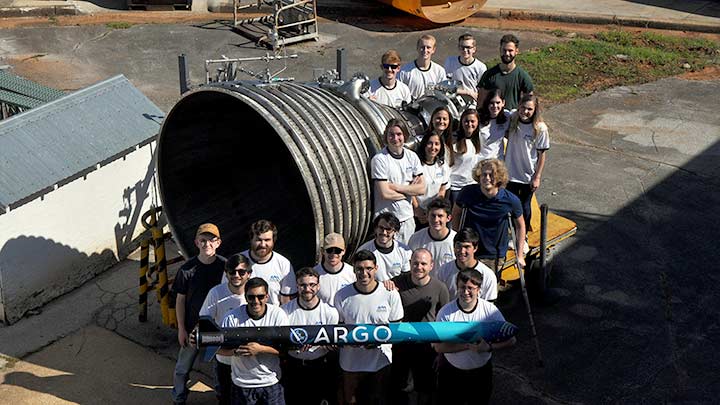 The Charger Rocket Works student team posing new a rocket engine ?>