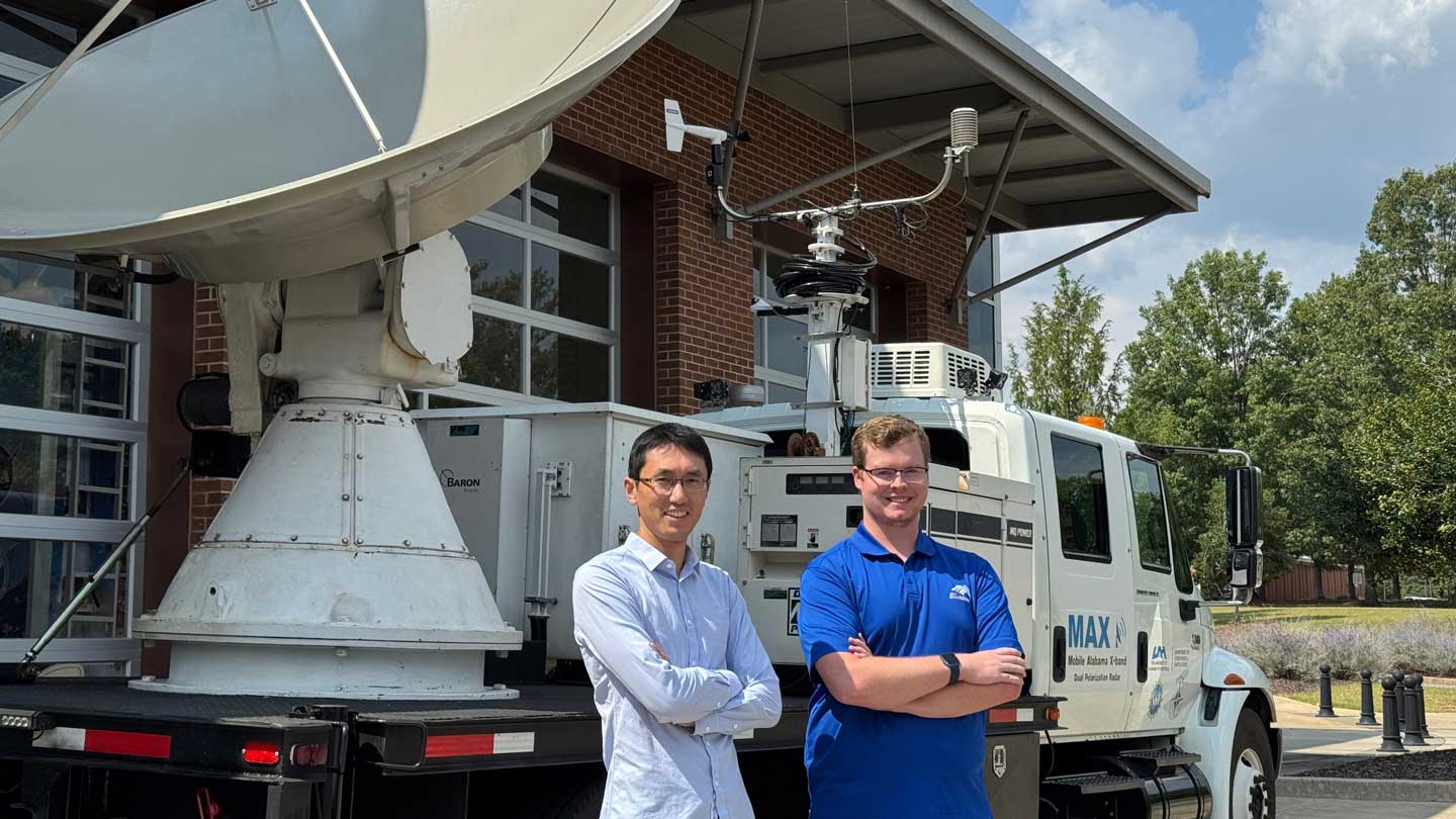 Dr. Xiaomin Chen and his student Zeb Leffler in front of UAH’s Mobile Alabama X-Band Radar.