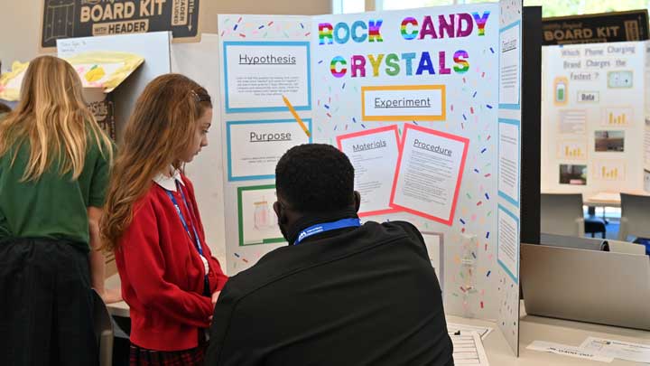 Susanna Box, a current 8th grader at Providence Classical School, describes her project “Rock Candy Crystals” to Oluwasegun Raji, a Ph.D. candidate at The University of Alabama in Huntsville (UAH) and a judge in the 2025 North Alabama Regional Science and Engineering Fair.