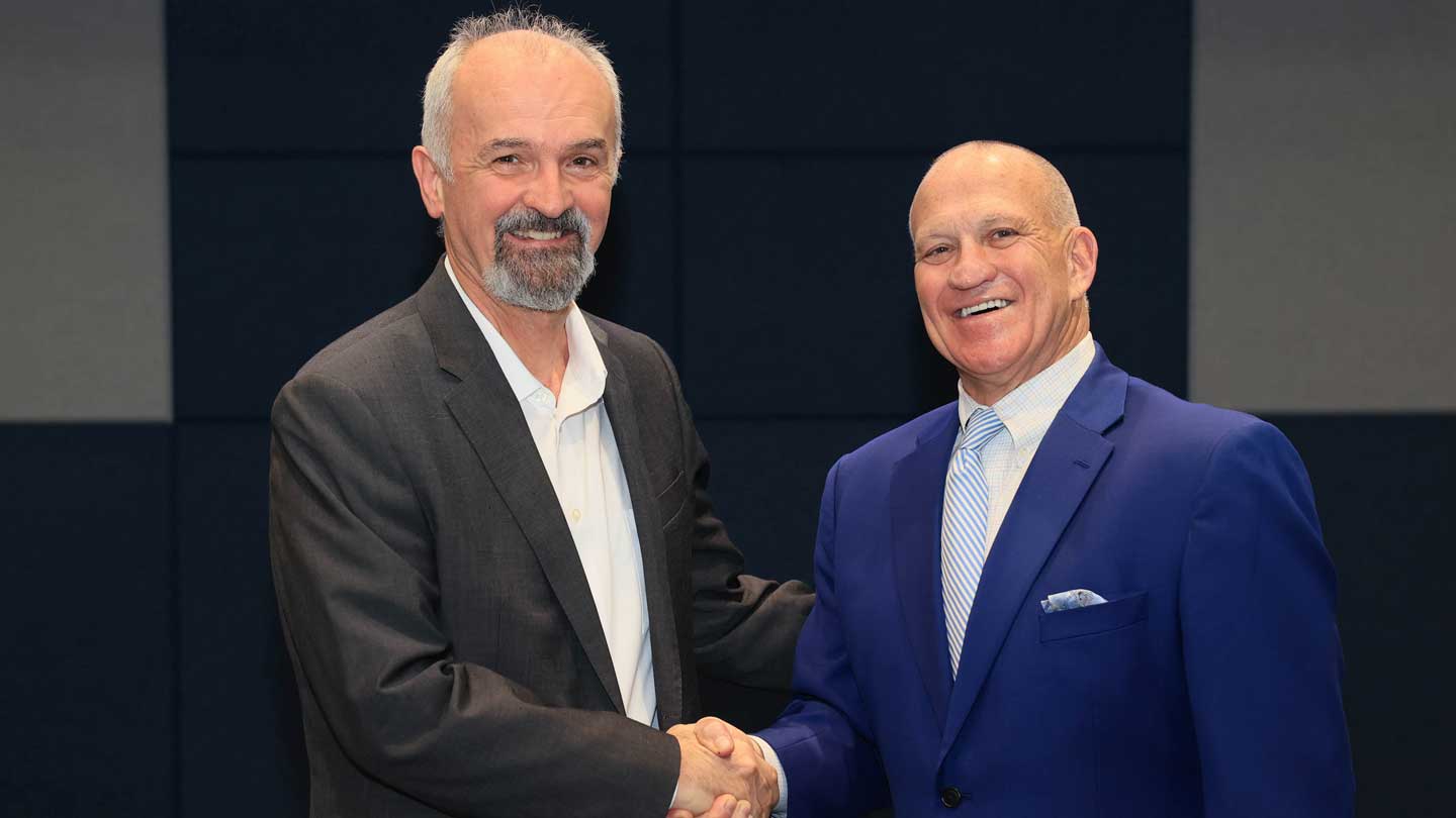 Dr. Emil Jovanov, a professor of electrical and computer engineering at The University of Alabama in Huntsville, with UAH President Charles L. Karr.