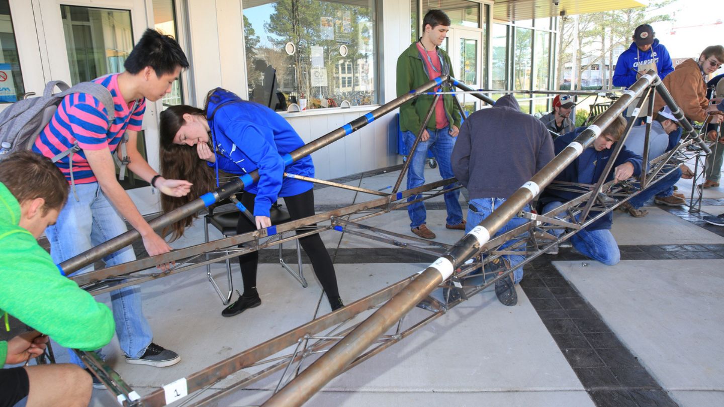 UAH College of Engineering students fabricating a collapsible bridge.