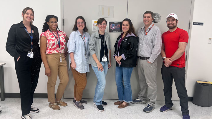 GEM-B2 team at NASA Kennedy Space Center (KSC) laboratory before launch. (L–R), Taylor Ranson (TSU),  Lanie Briggs (UAH), Amy LeBleu DeBartola (UAH), Tanya Sysoeva (UAH), Yo-Ann Vélez Justiniano (MSFC), Jonathan Wilson (MSFC), Eric Bietle (MSFC)