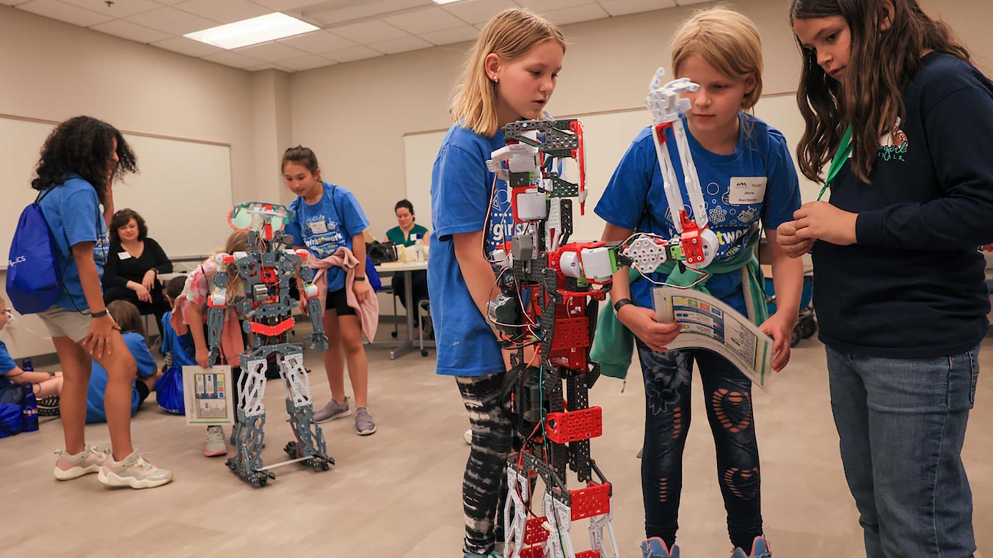 Students interact with different types of robots