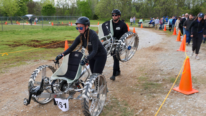 UAH rover pilots Sami Harris (front) and Tanner Cowart (rear) carrying wounded ATHENA rover toward finish line.