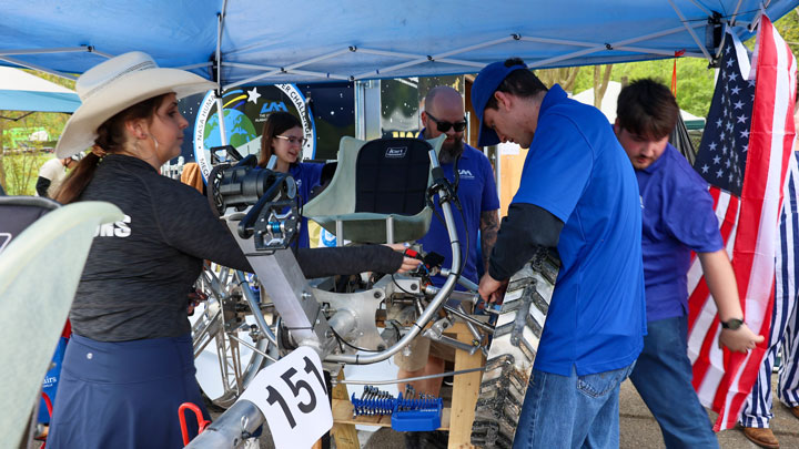 Frantic efforts to repair the Advanced Terrain Human Exploration Navigating Apparatus (ATHENA) rover to be ready for the next day’s excursion.