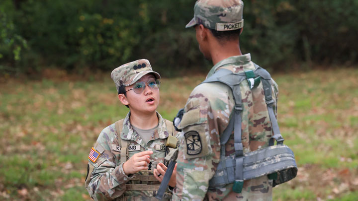 Army ROTC Cadet Heidi Kaeding talks with another cadet during field training exercises on Redstone Arsenal