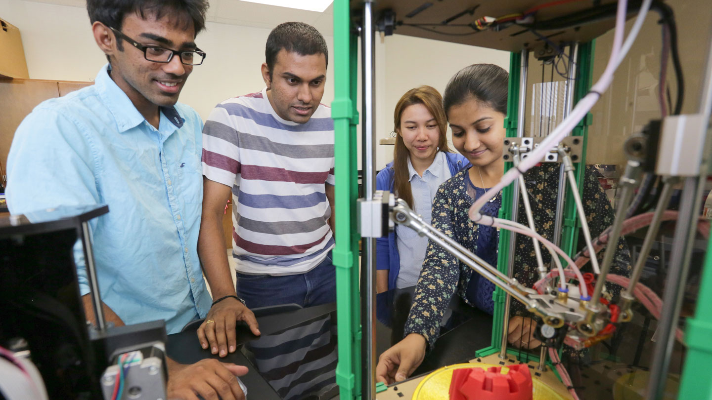 Students working with a 3D printer in the Industrial and Systems Engineering and Engineering Management Department labs at The University of Alabama in Huntsville.