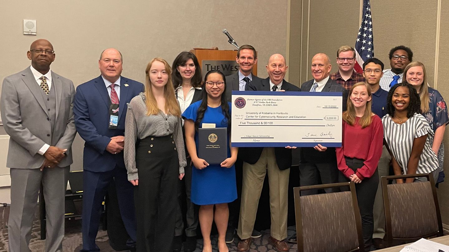 UAH President Charles L. Karr celebrates with CCRE Director Tommy Morris and scholarship recipients.