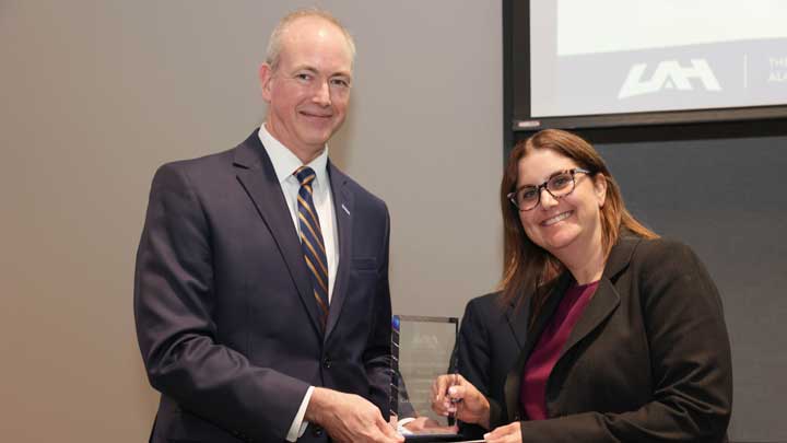 Dr. Jason Greene, left, dean, College of Business, presents the Outstanding Faculty Award to Dr. Karen Anne Wallach.