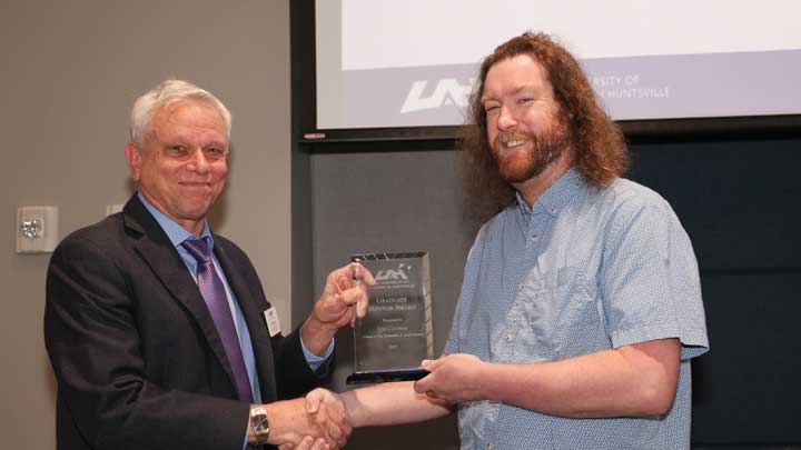 Dr. Jon Hakkila, left, associate provost for international services and academic integrity and dean of the Graduate School, presents the Graduate Mentor Award to Dr. Joe Conway.