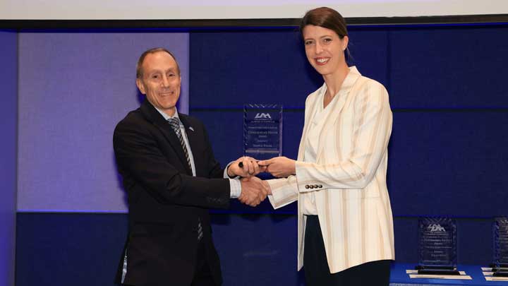 Dr. Kristin Weger, UAH associate professor of psychology, receiving an award from Dr. David Puleo, UAH provost and executive vice president for academic affairs.