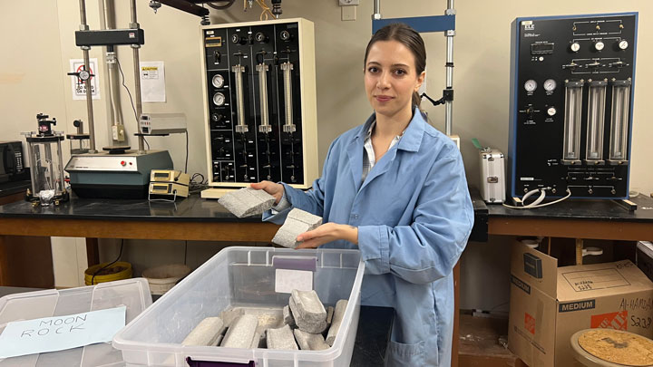 Ledia Shehu, UAH civil engineering doctoral candidate showing moon rock.