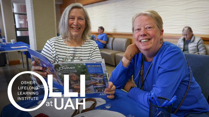 Two eldery women smiling assisting Osher Lifelong Learning Institute in UAH.
