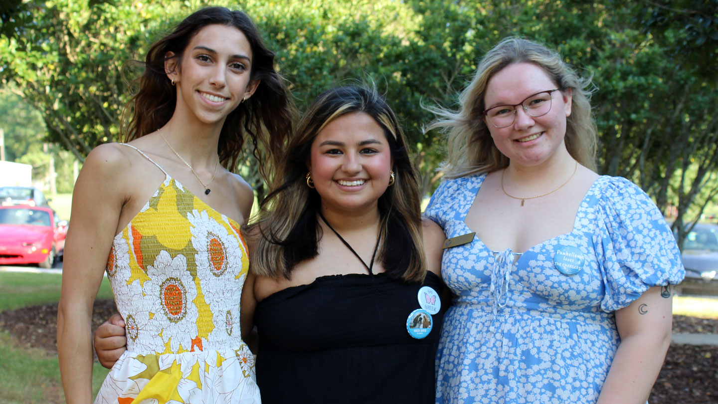 NPC members Torri Walker, left, of Kappa Delta; Leslie Gonzalez, center, of Alpha Omicron Pi, and Julia McCullars of Delta Zeta invite UAH students to explore a slice of Greek life on campus. 