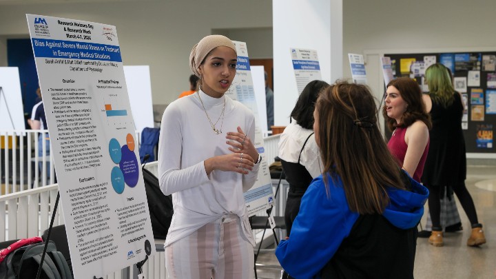 Student from The University of Alabama in Huntsville standing in front of a group of people