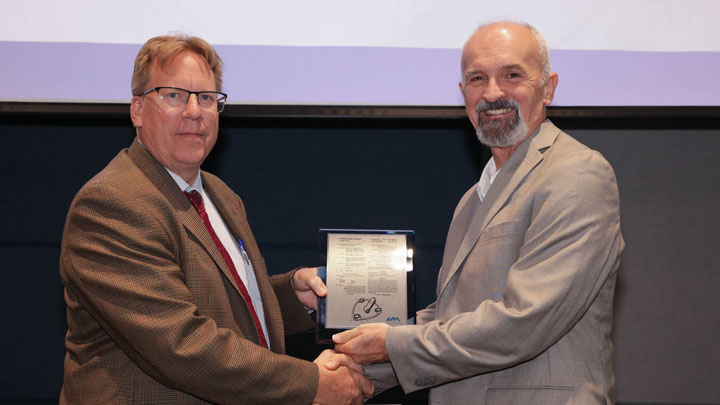 Robert Lindquist, left, congratulates Emil Jovanov for “Multi-Modal Heart Diagnostic System and Method.