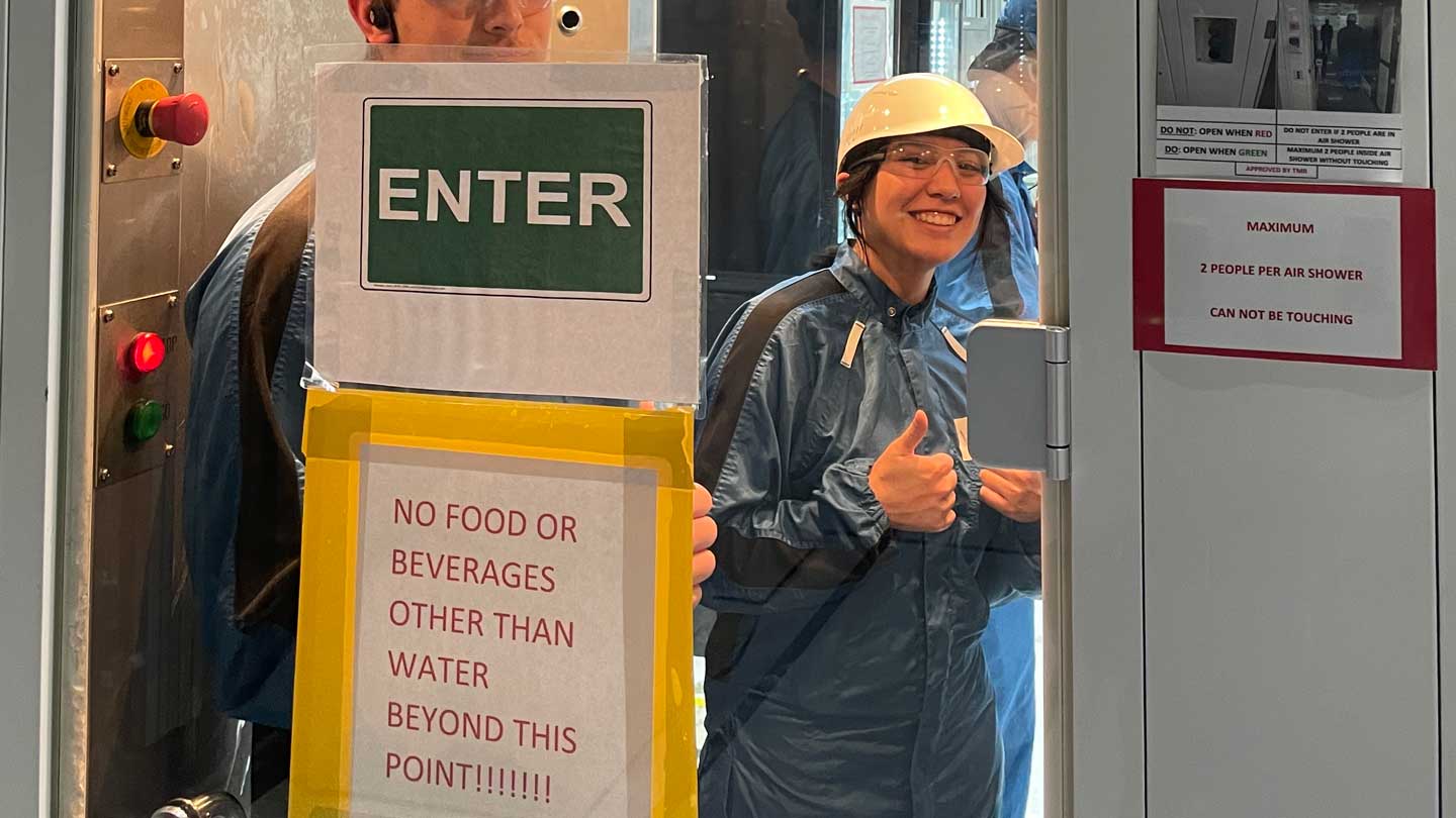 Sabrina Adhami (yellow hat), UAH psychology student, in the paint shop at Mazda Toyota Manufacturing (MTM) as a Human Resources Development intern. 